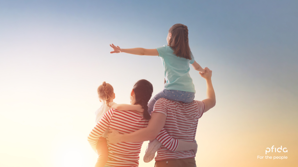 Family of four with child on father's shoulders looking into the sunset | 3 Key Lessons from the Halal Homebuying Scholars Roundtable 